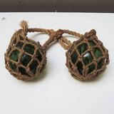 Old glass fishing float with rope net