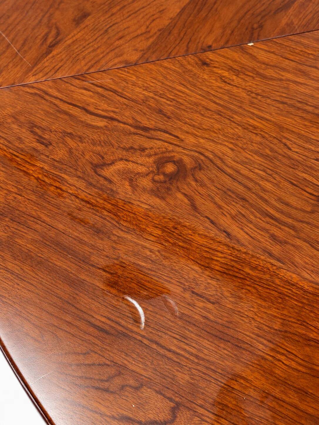 Large round dining table with black blade legs.