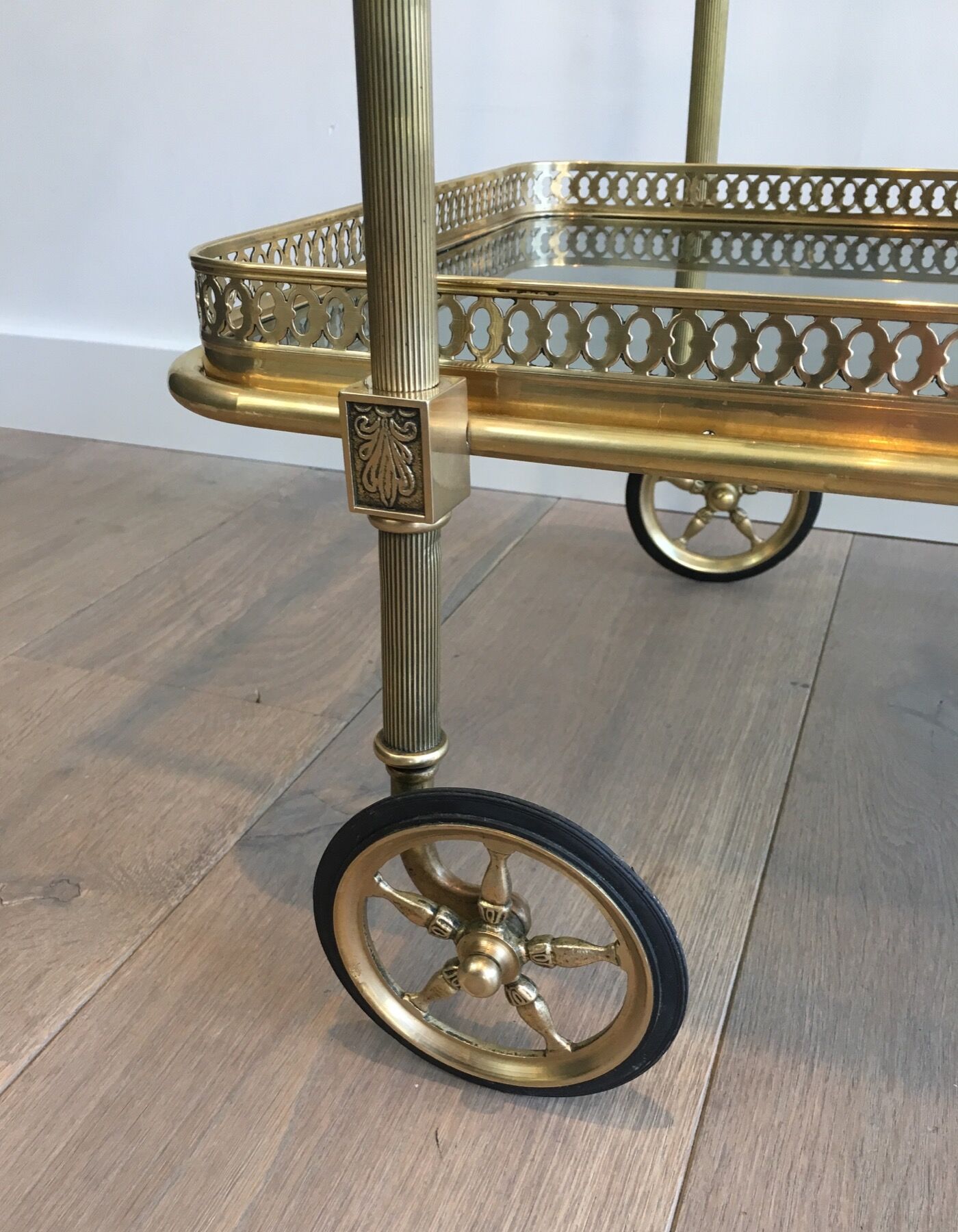 Neoclassical style rolling table in brass with blue glass tops