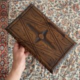 Low stool in carved wood