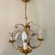 Golden metal chandelier decorated with flowers