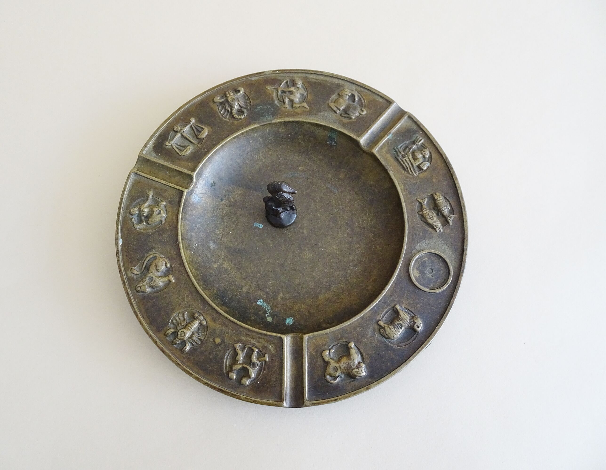 Luxa brass ashtray with zodiac relief and embers killer