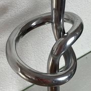 Pair of large aluminium bow candlesticks, Italy, 1970.