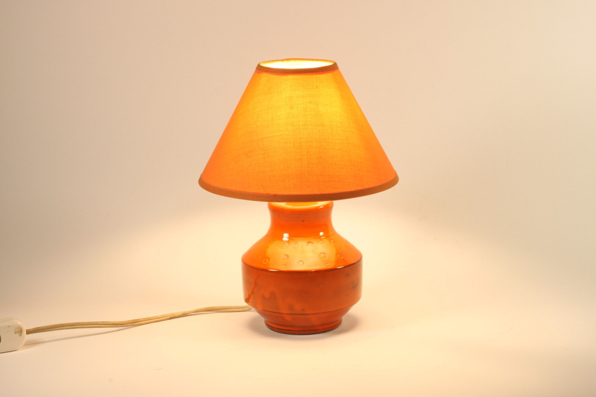 Orange ceramic table lamp with geometric imprints, 1970s.