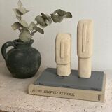 Set of two minimalist stone face statues
