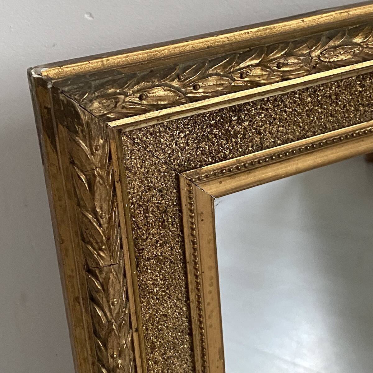 Small wooden mirror with gilded stucco in the Louis XVI style.