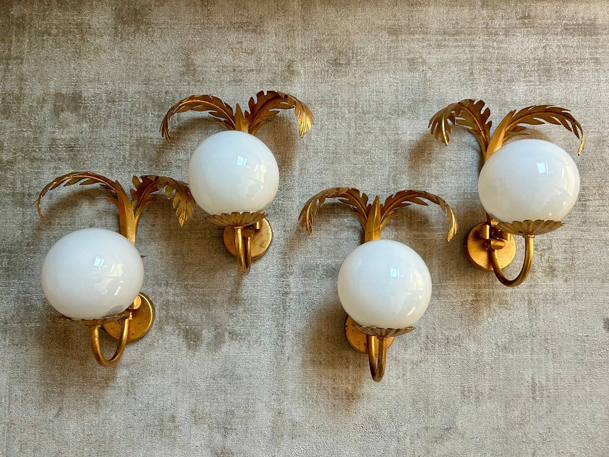 Pair of palm leaf wall lights in Hollywood Regency style with opaque globes by Hans Kögl, Germany, 1970s.