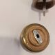 Varnished wood and brushed brass pepper mill