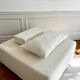 Square ottoman and its cushions in buckle fabric