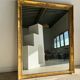 Miroir doré style Restauration à décor de palmettes étirées