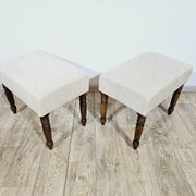 A pair of English upholstered pouffes/footstools from the 19th century