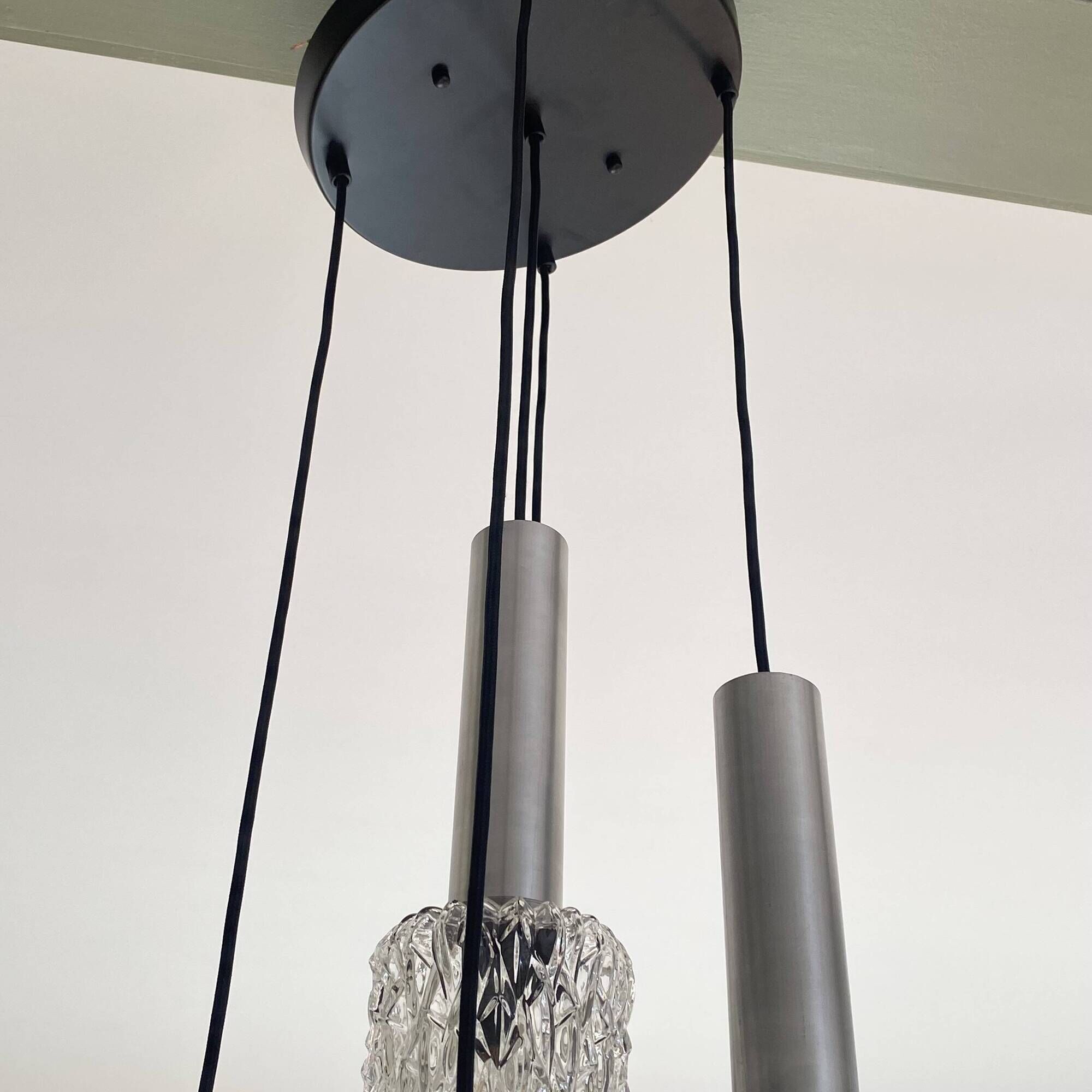 Large cascading chandelier with 5 glass lampshades and aluminium tube.