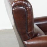 Comfortable and correct dark antique sheepskin English armchair in very good condition