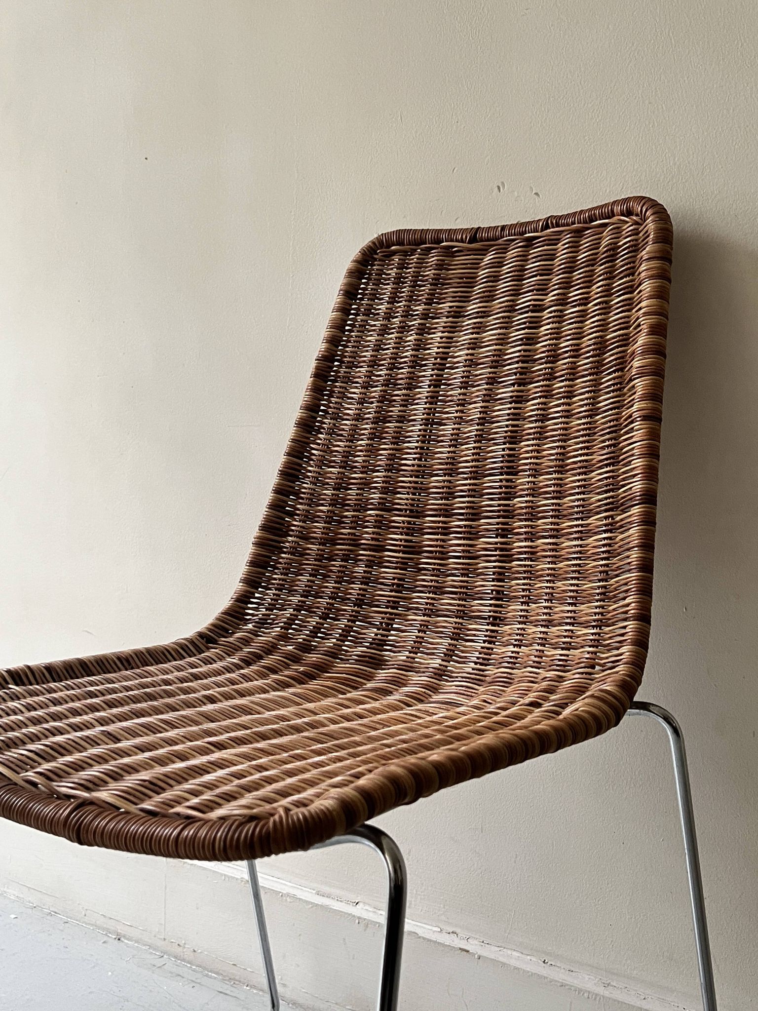 Chair design in rattan, woven wicker and chrome wire metal.
