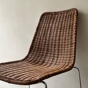 Chair design in rattan, woven wicker and chrome wire metal.