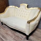 Banquette vintage à dossier capitonné, revêtu d’un tissu ivoire