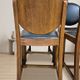 Set of four vintage wooden dining chairs with black leather upholstery