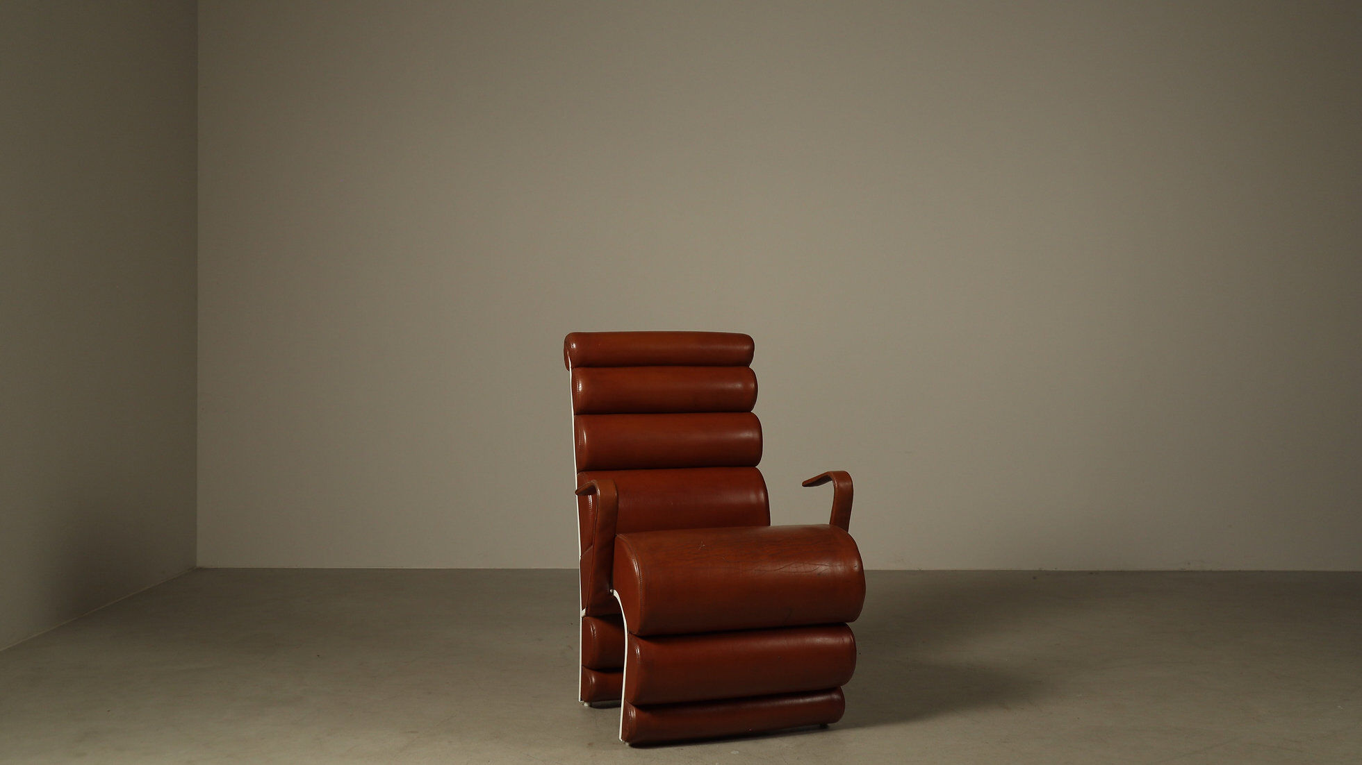 Pair of sculptural cognac leather armchairs, 1970s