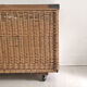 Old large wicker laundry basket on wheels