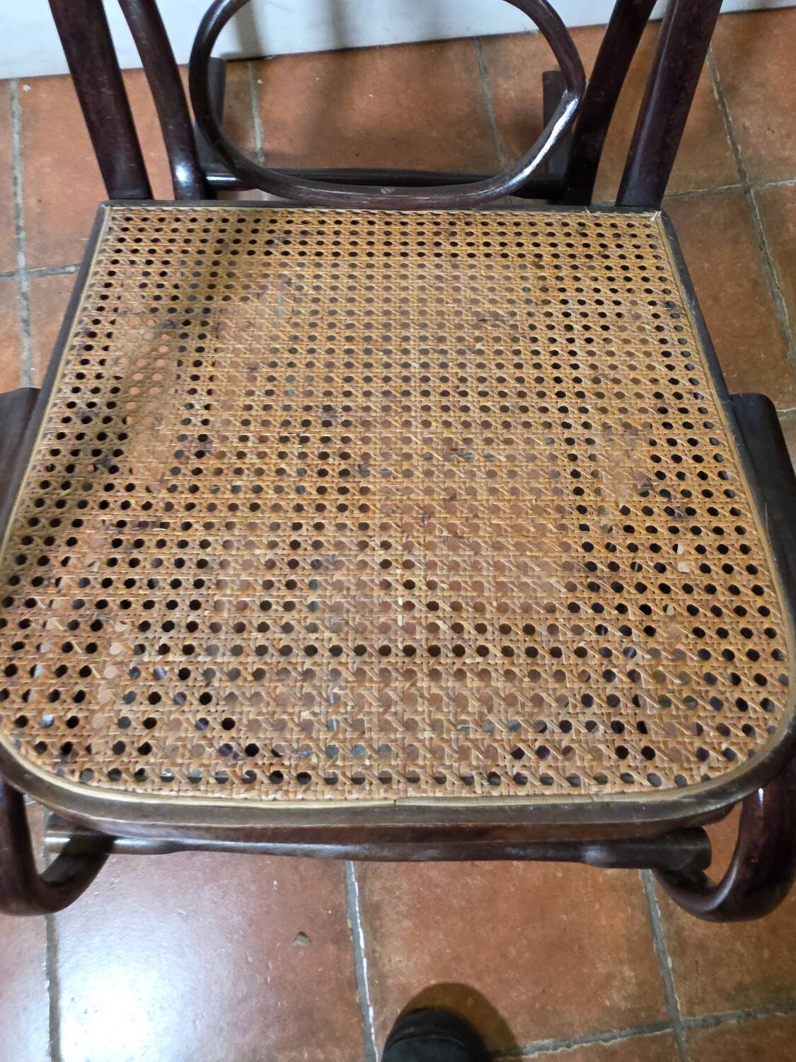 Curved wooden rocking chair with caning