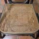 Curved wooden rocking chair with caning