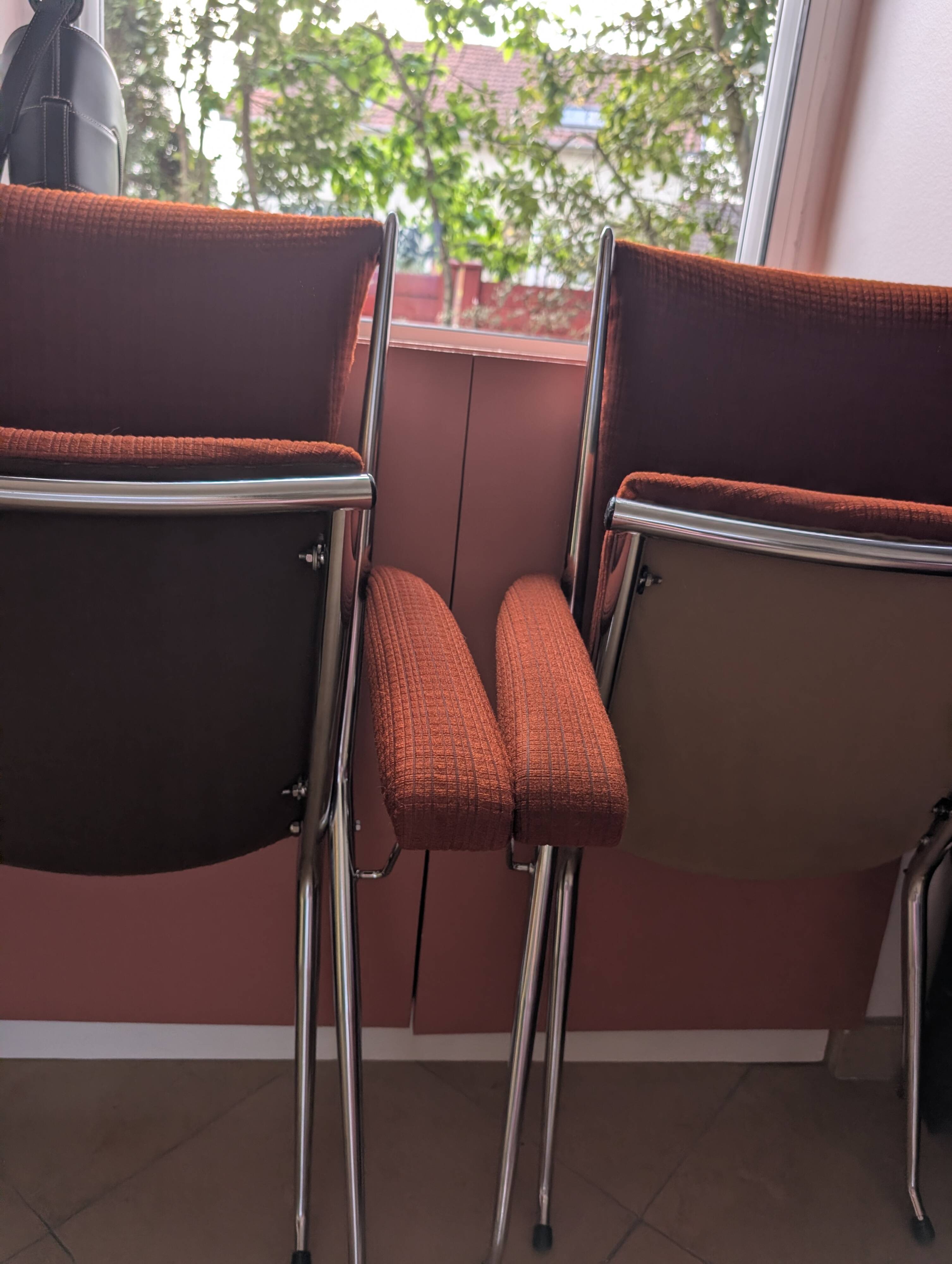Pair of vintage folding chairs in terracotta fabric.