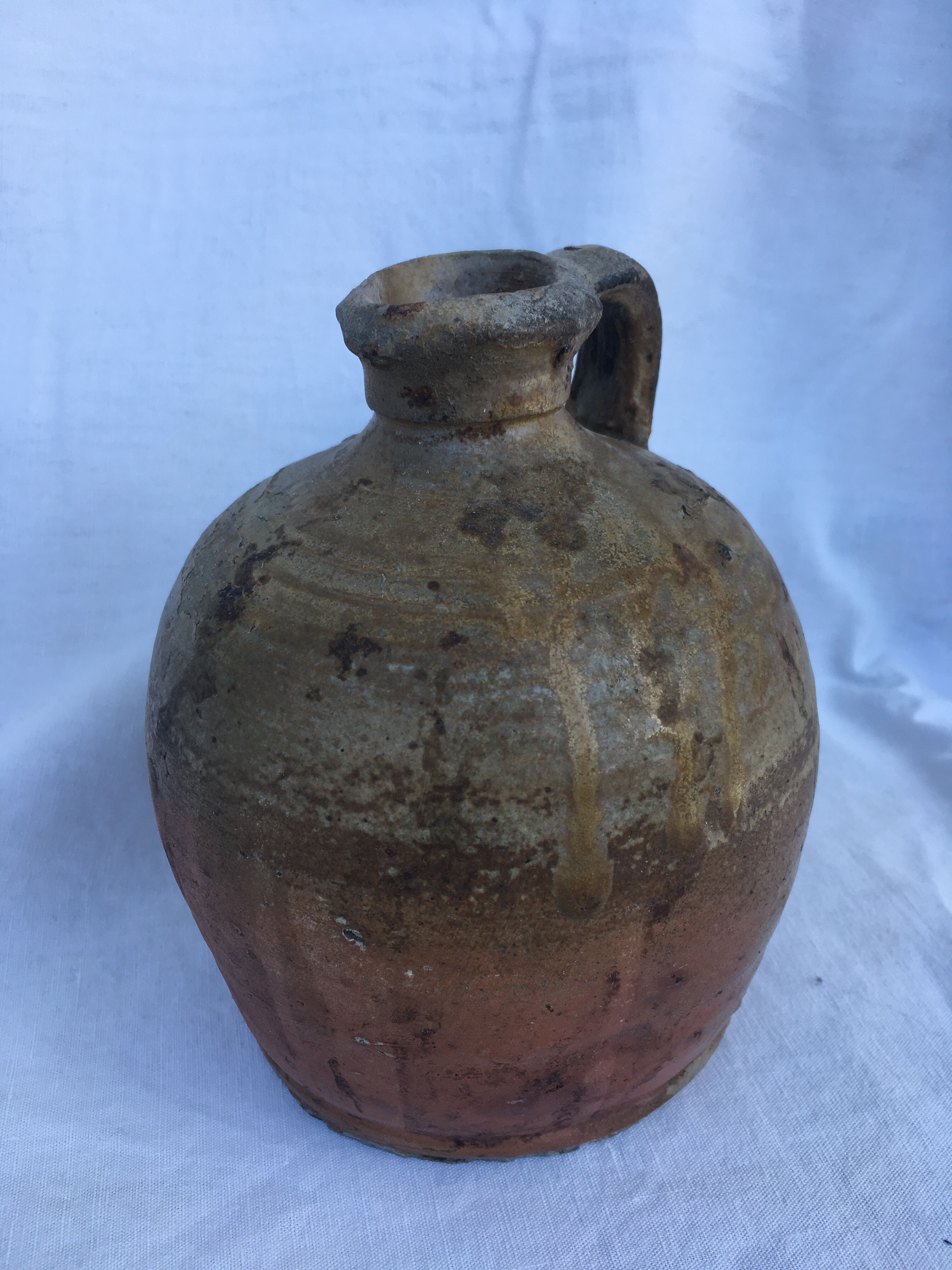 Ancient jug in glazed sandstone
