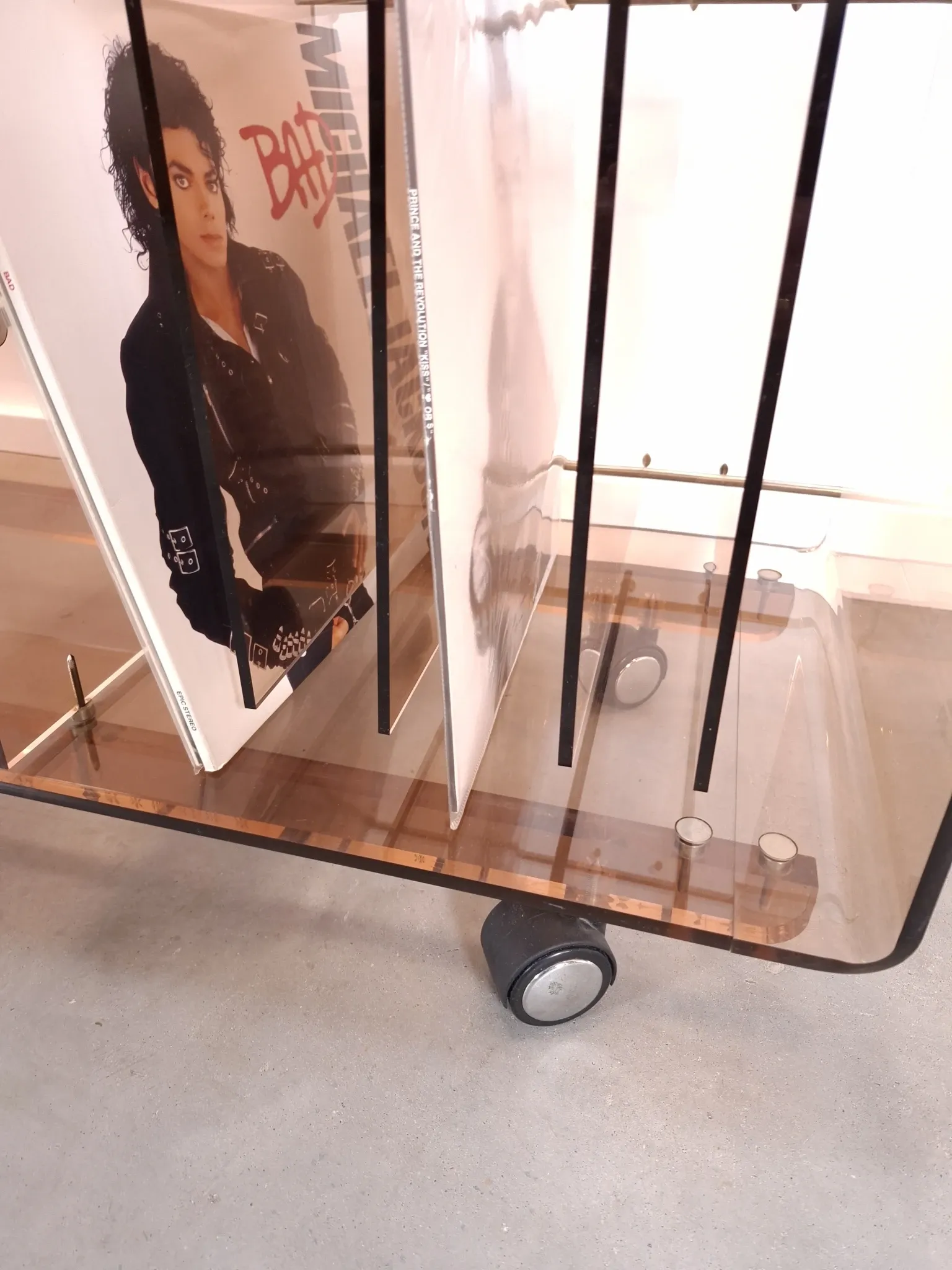 Vintage hifi, LP cabinet, TV unit made of tinted plexiglass on wheels, records.