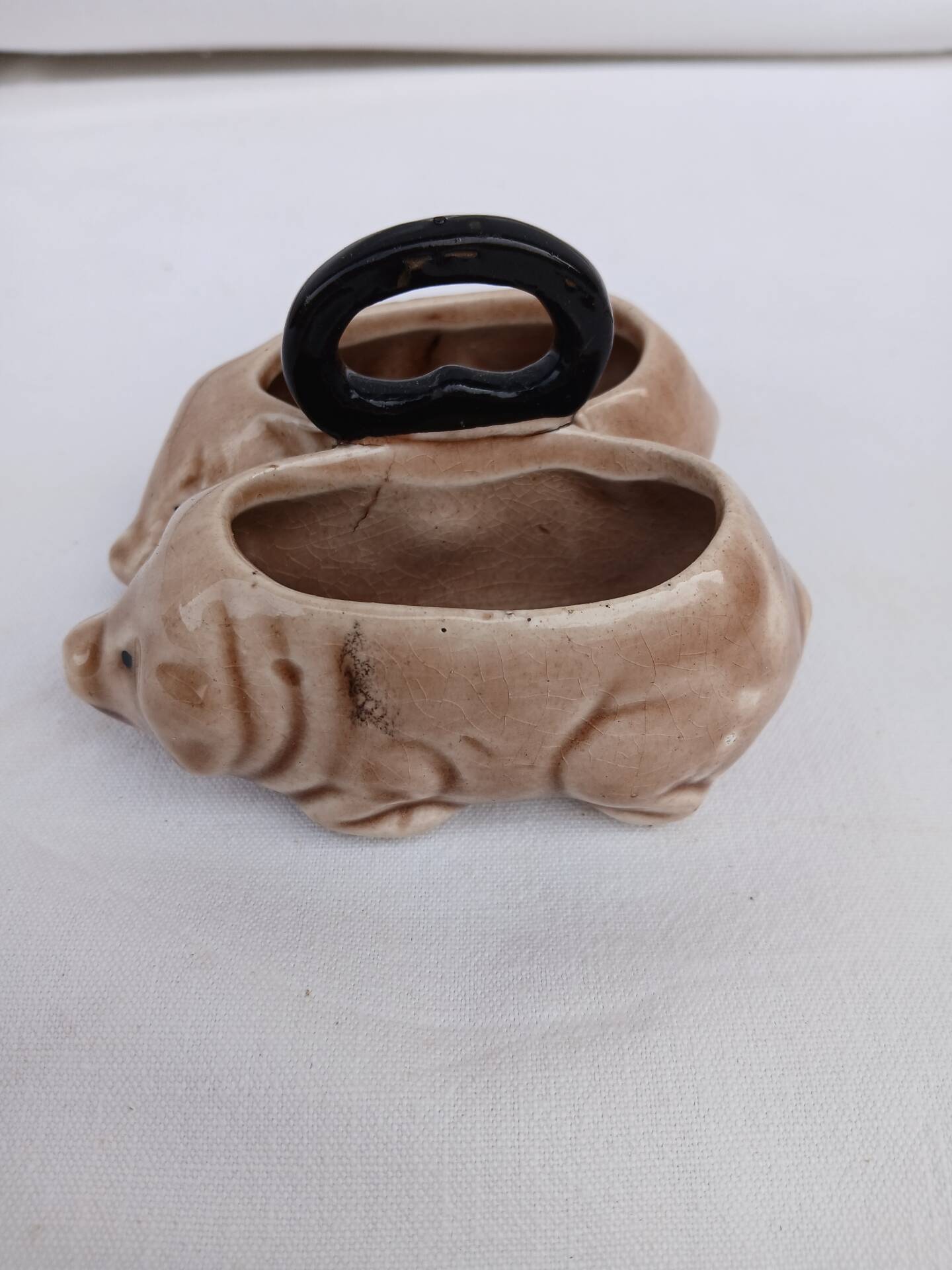 Old ceramic salt and pepper shaker in the shape of pigs.