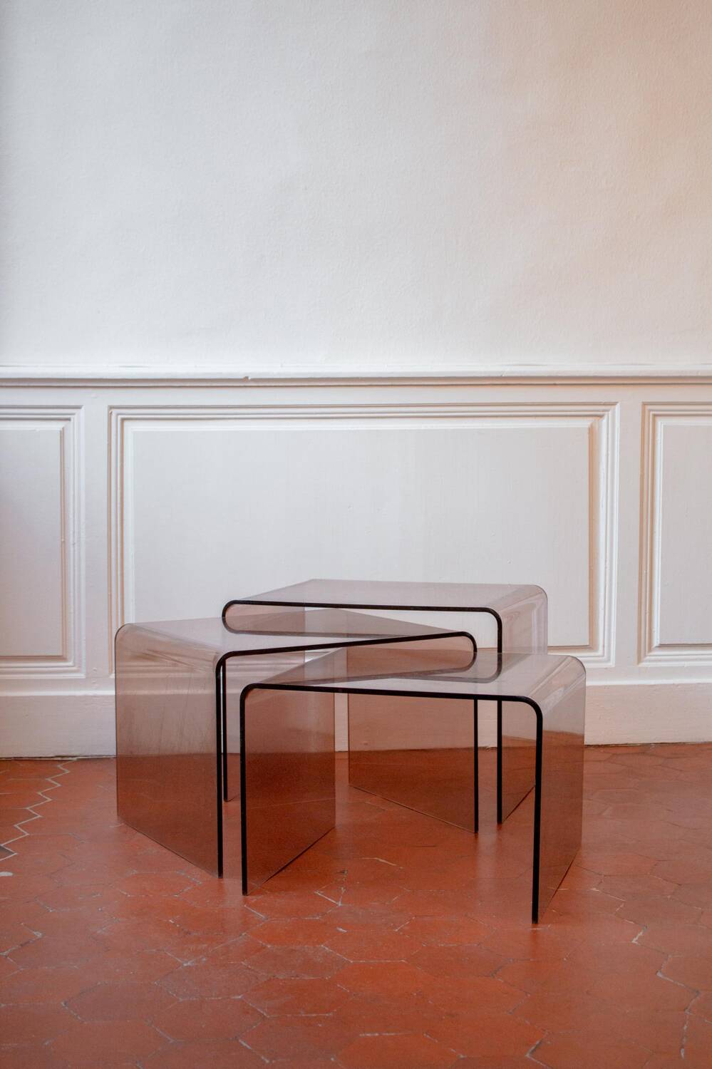 Vintage trio of nesting tables in smoked plexiglass by Michel Dumas, year.