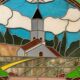 Art Deco stained glass window decorated with a 20th century church steeple