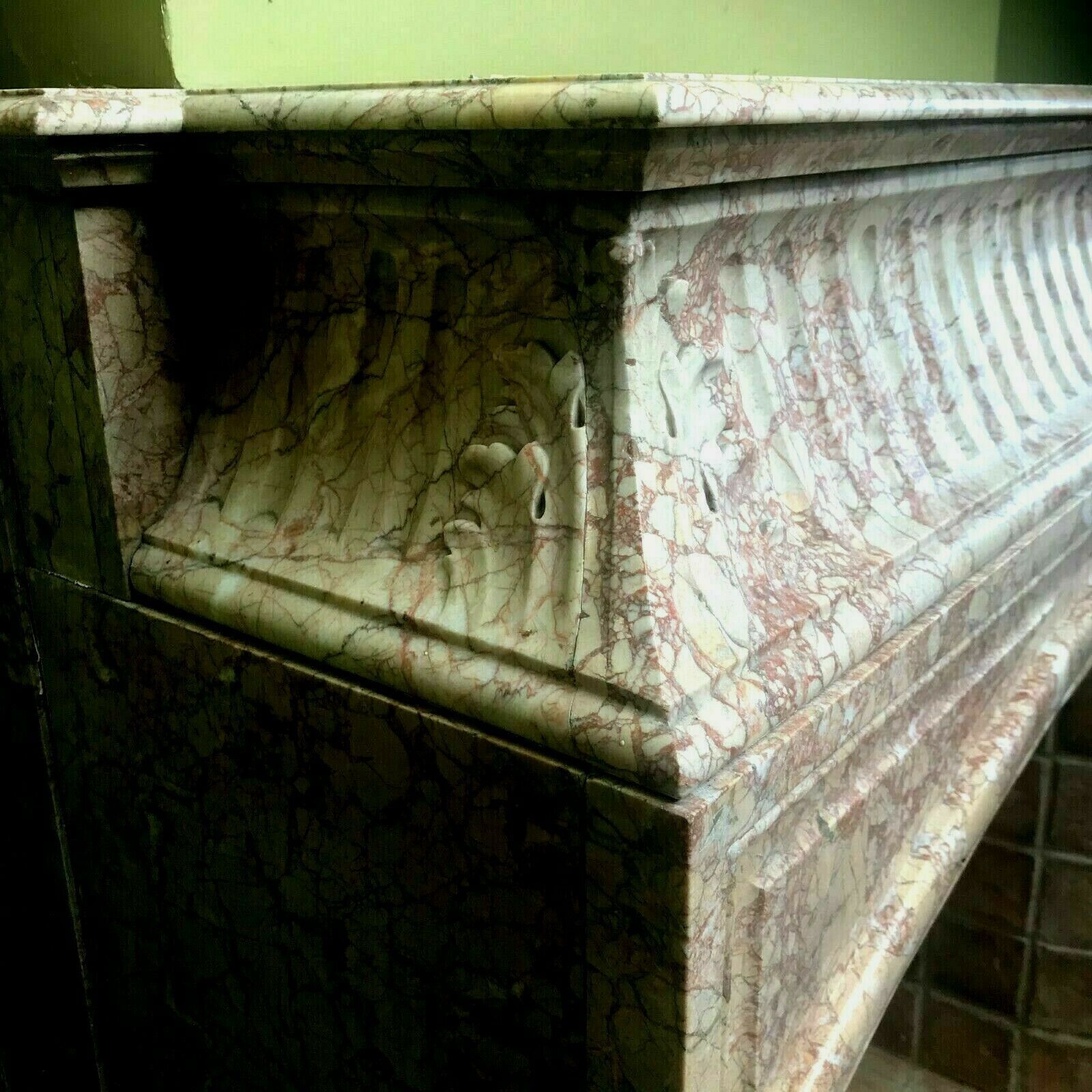 Louis XIV-style fireplace has 19th century veined pink marble hood