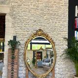 Oval mirror with pediment, beaded gilded with gold leaf
