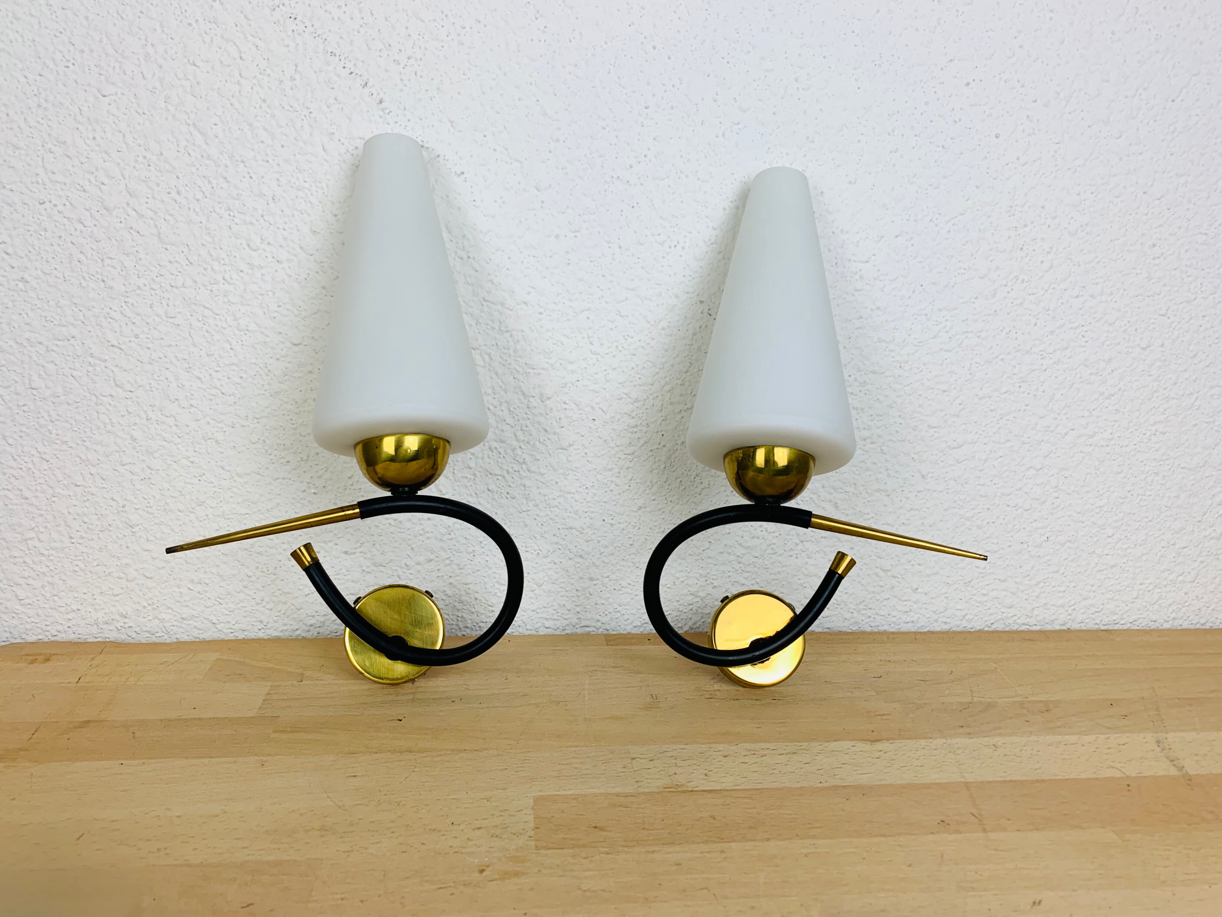 Pair of Arlus 50s opaline black and golden brass wall lamps