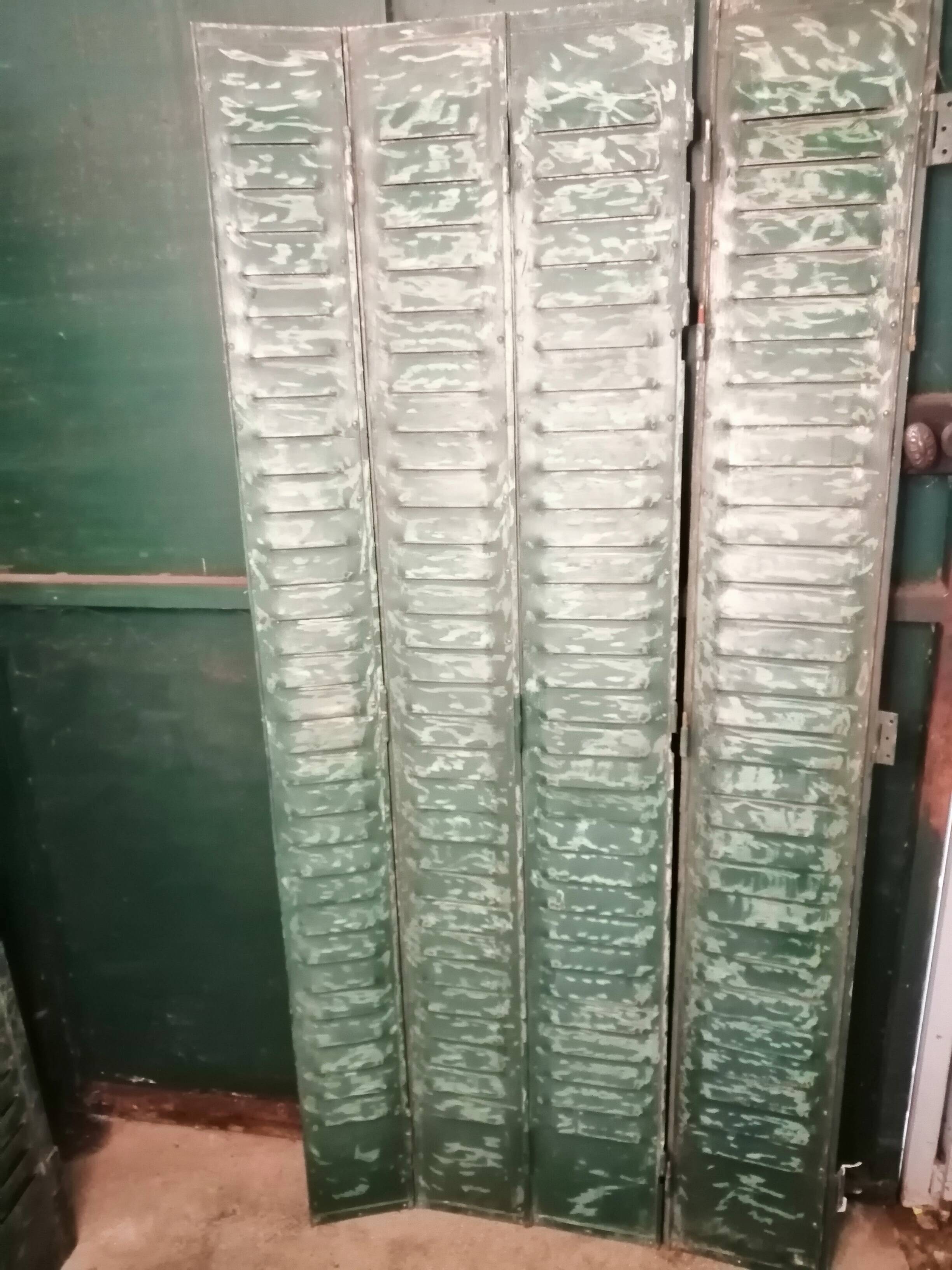 Lot of old green shutters in 4-part iron screen headboard