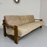 Old 3-seater sofa in solid wood, Maison Regain design, from the 70s.