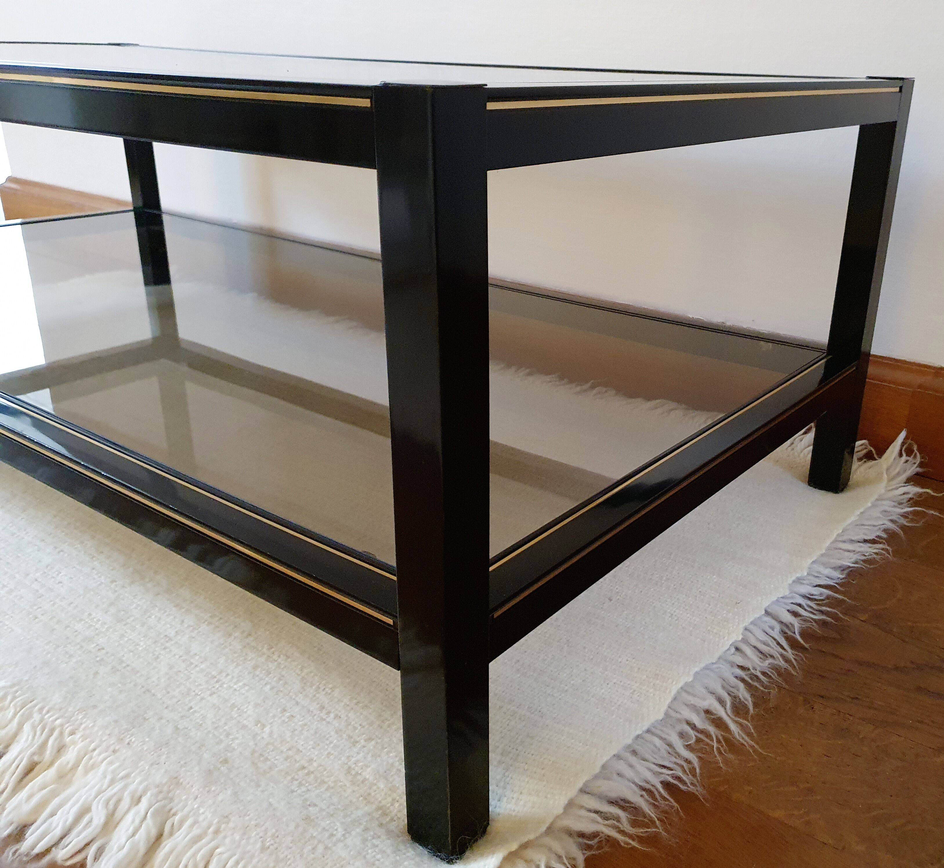 Black and gold coffee table with a double smoked glass top