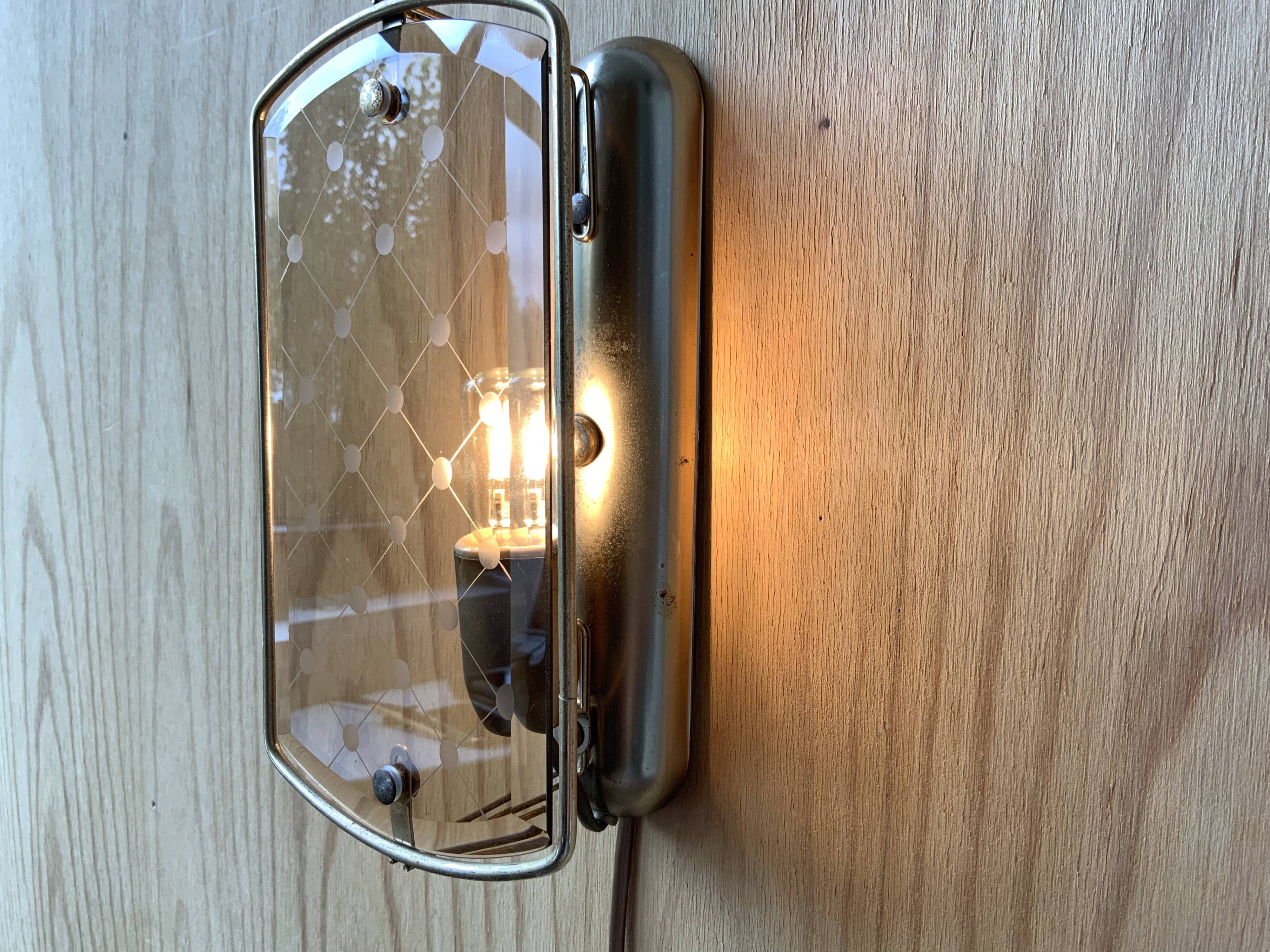 Brass wall lamp and smoked glass