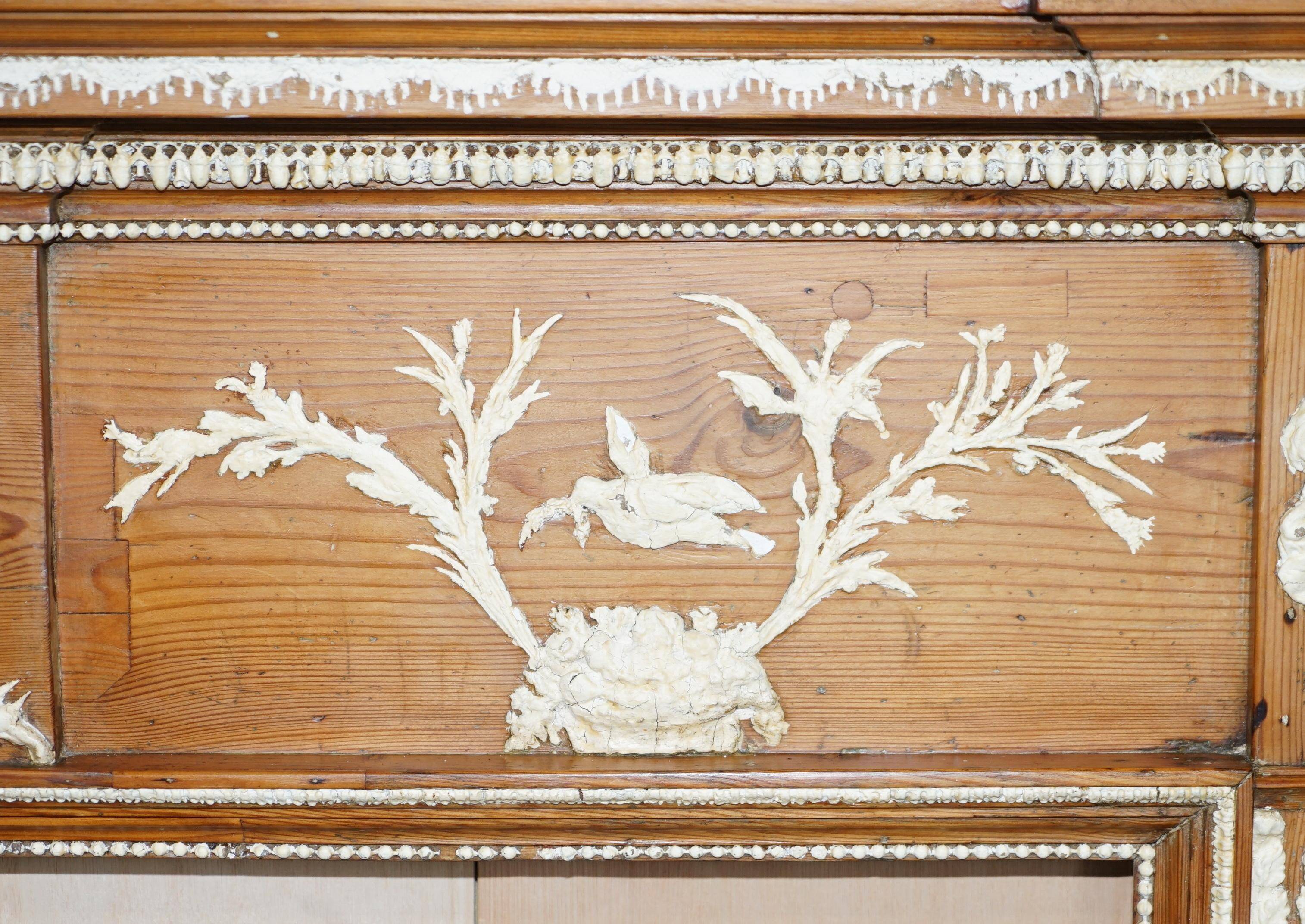Victorian antique fireplace in tarred pine and sculpted gesso.