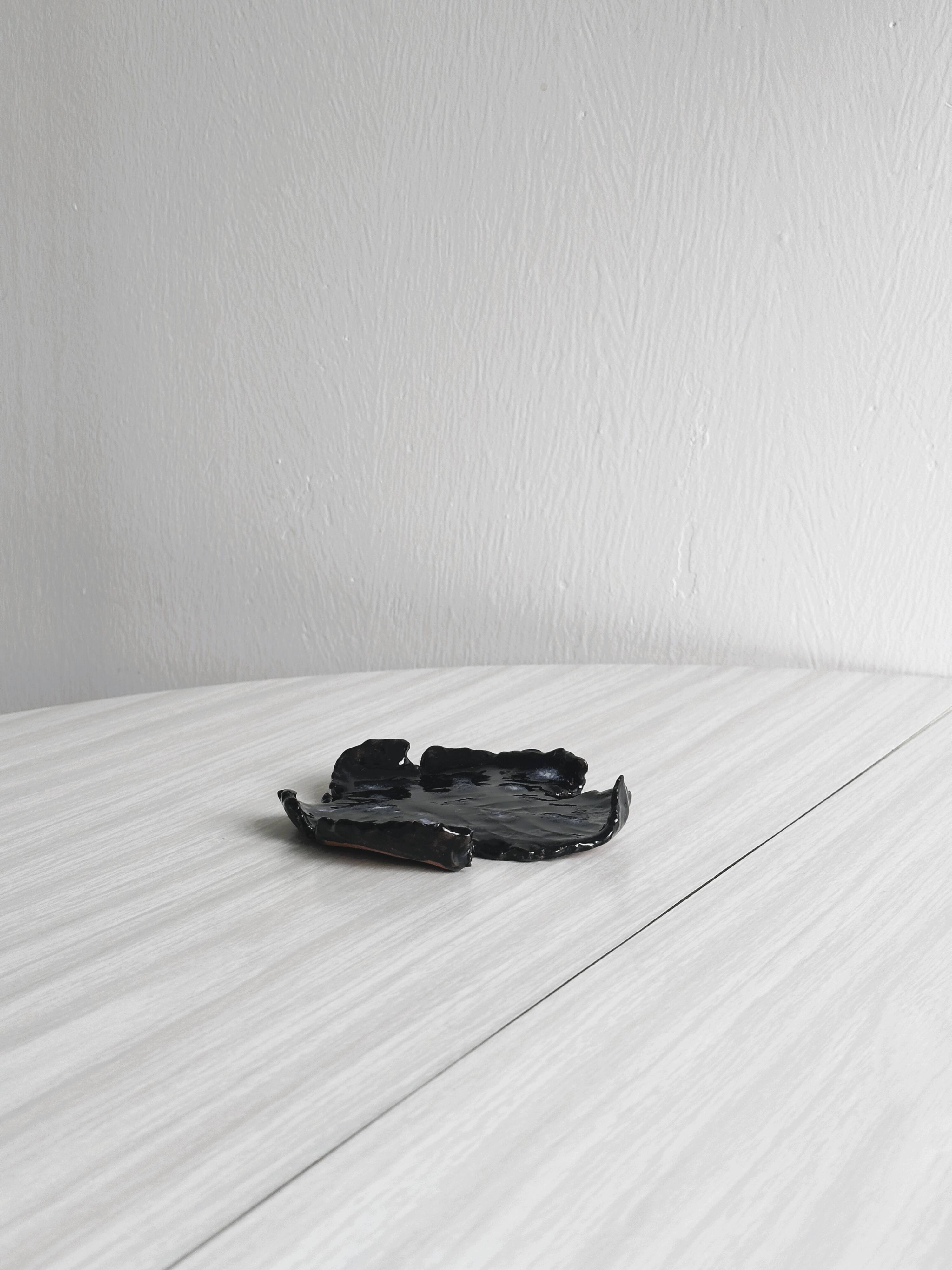 Handcrafted enameled black ceramic pocket emptier