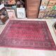 Large red Bokhara-style oriental carpet 300x200 cm with gul patterns.