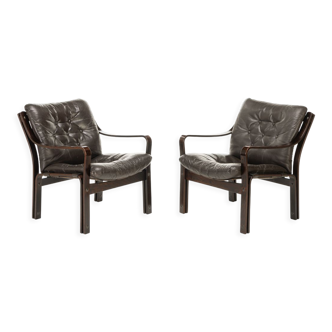 Pair of easy chairs in dark brown leather