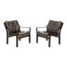 Pair of easy chairs in dark brown leather