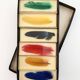 Six feather-shaped knife rests in resin inclusion.