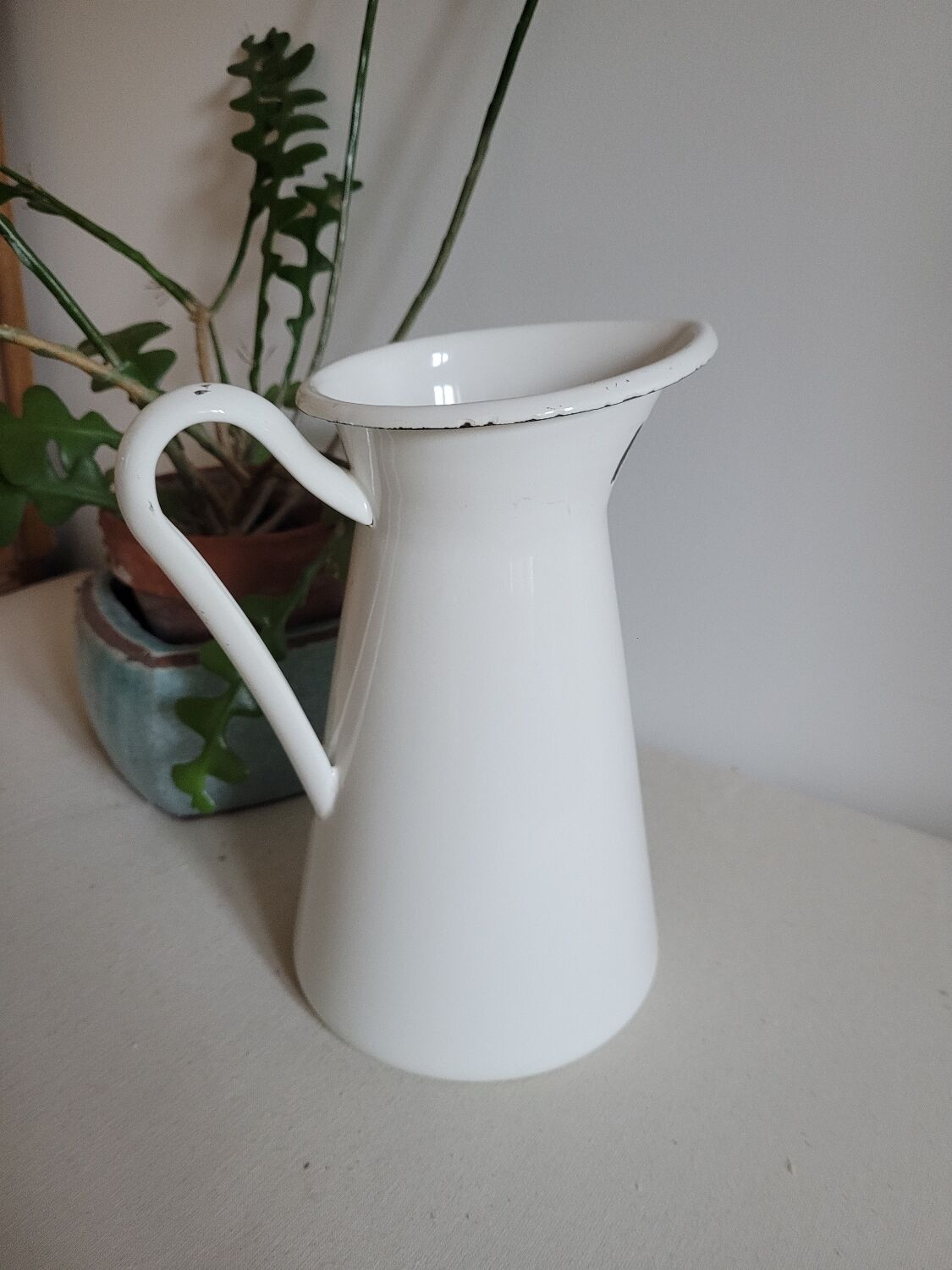 White enamelled metal jug