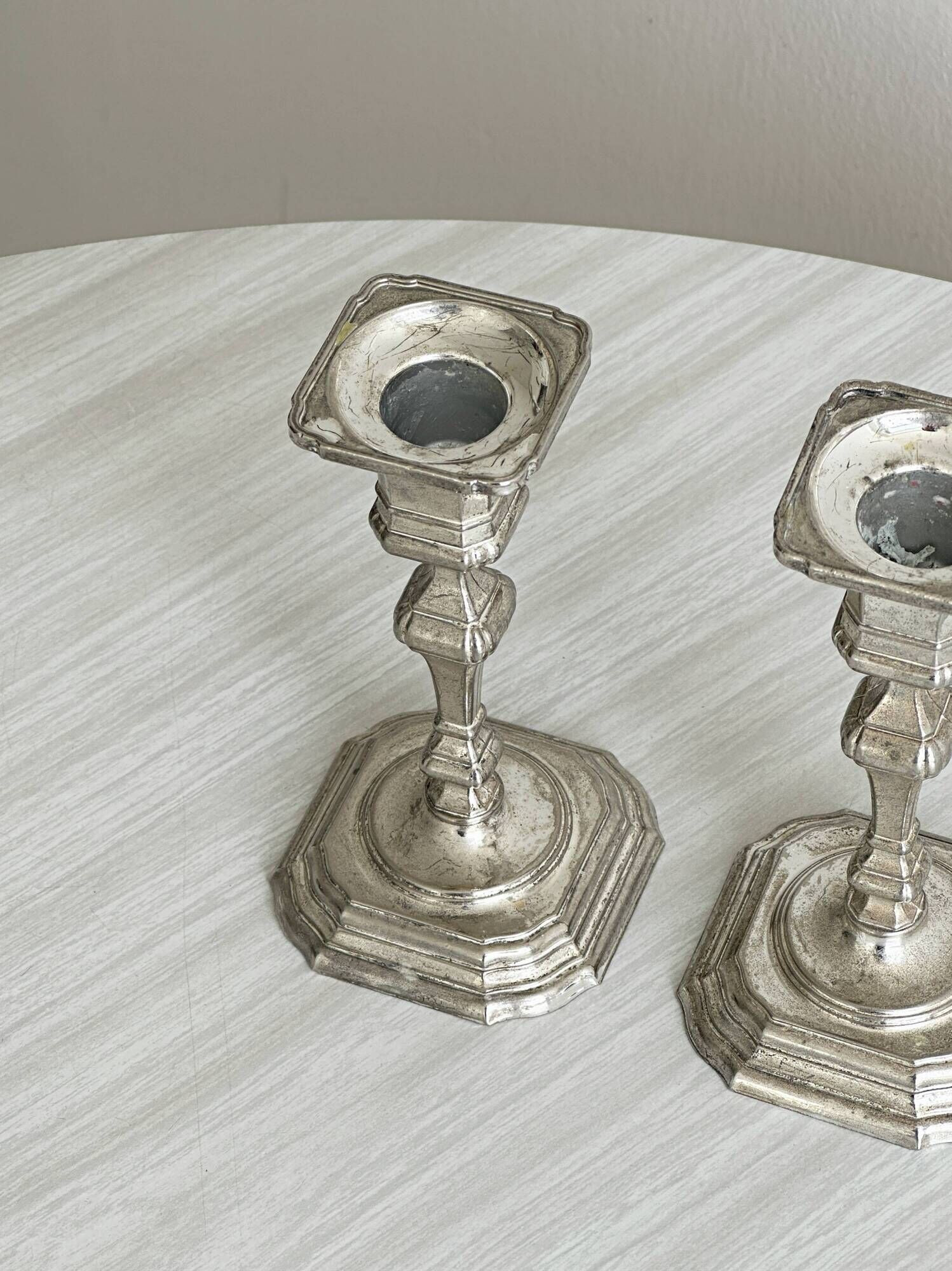 Pair of patinated silver-plated candlesticks