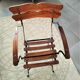 Folding garden chair with teak slats on a wrought iron structure