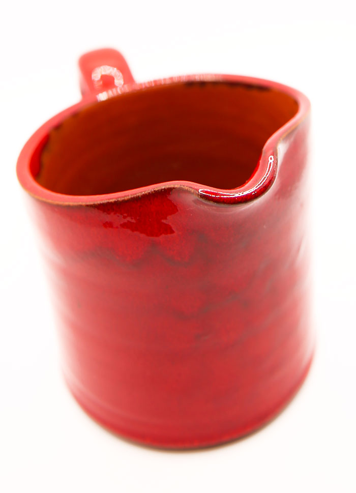 Bright red ceramic pitcher
