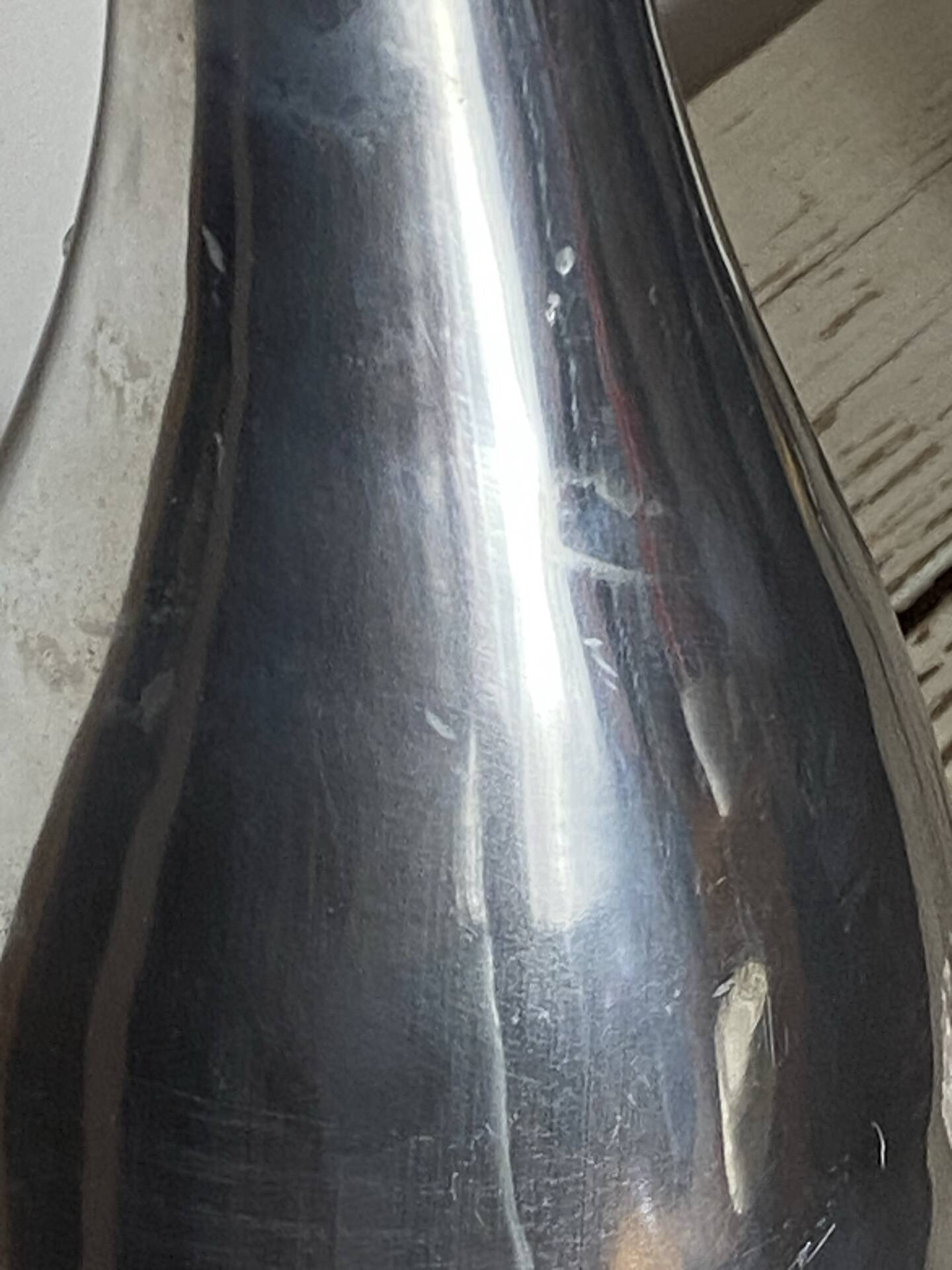 Large organic vase in polished aluminium cast.