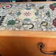 New oak storage furniture with a signed artisanal mosaic top.